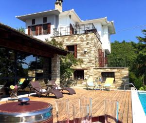 a house with a swimming pool and a patio at Art Luxury Resort Villa in Áyios Vlásios