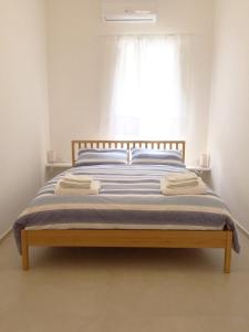 Postel nebo postele na pokoji v ubytování Ortigia Desire