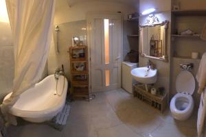 a bathroom with a tub and a toilet and a sink at Apartment Vintige in Cluj-Napoca