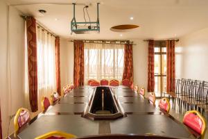 a conference room with a long table and chairs at Reinah Tourist Hotel Fort Portal in Fort Portal