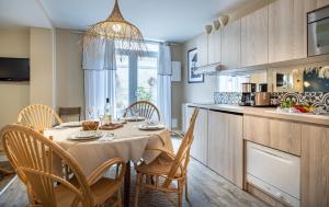 a kitchen and dining room with a table and chairs at Appartements & Spa de la Marine Loire in Montsoreau