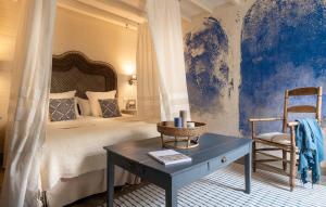 a bedroom with a bed and a table and a chair at Appartements & Spa de la Marine Loire in Montsoreau +61 photos