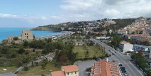 a town on a hill with a road and the ocean at B&B Casa Alessandro in Scalea