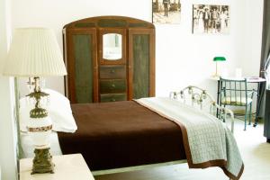 a bedroom with a bed and a table with a lamp at Condesa Haus B&B in Mexico City
