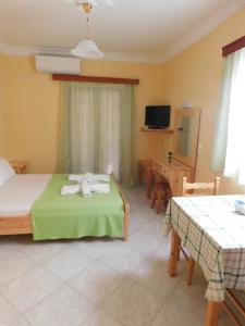 a bedroom with a bed with a teddy bear on it at To Spiti Tis Eirinis in Poros