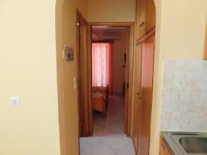 a hallway leading to a kitchen with a table at To Spiti Tis Eirinis in Poros +68 photos