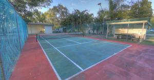 a tennis court with a net on top of it at Discovery Parks - Tannum Sands in Tannum Sands
