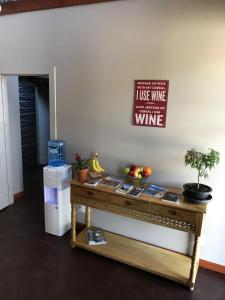 a table with a bottle of water and a sign on it at Wesbert Winery & Guest Suites in Penticton