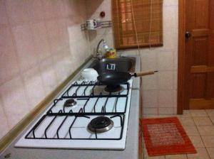 a kitchen with a stove with a pot on it at Marina Condominium Holiday Homestay in Kota Kinabalu
