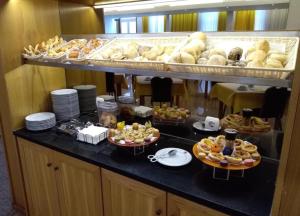
a counter filled with lots of different types of food at Hotel Boa - Vista in Porto
