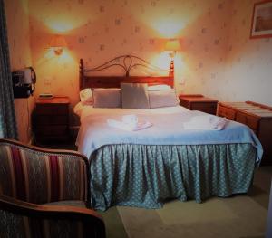 a bedroom with a bed with two towels on it at The Imperial Hotel in Castle Douglas +10 photos