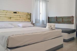 a bedroom with a large bed with towels on it at Paleochori Studios in Paliochori