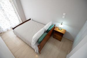 a small bedroom with a bed and a night stand at Ari's Apartment in Vonitsa