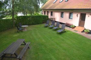 a group of chairs and a picnic table in a yard at Haus Simone in Insel Poel