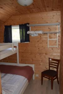 a bedroom with bunk beds in a cabin at Hesthaug Gard in Eidsdal