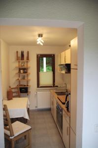 a kitchen with a table and a counter top at Bungalow am Forsthaus Stagnieß in Ueckeritz