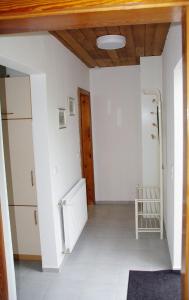 a hallway with white walls and a wooden ceiling at Bungalow am Forsthaus Stagnieß in Ueckeritz