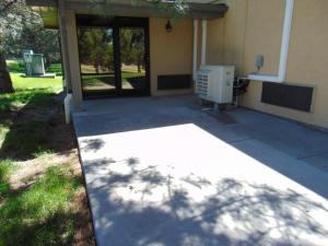 a building with a patio with a air conditioner at Horse Creek Inn in McCook