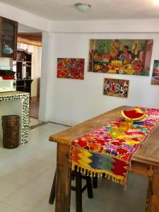 a wooden table with a colorful table cloth on it at Ch'ejum bungalow in Cancún