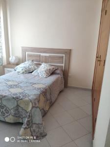 a bedroom with a bed with two pillows on it at ApartaClub la Barrosa in Chiclana de la Frontera