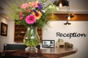 a vase filled with flowers sitting on a table at Pier Beach Hotel Apartments in Limassol