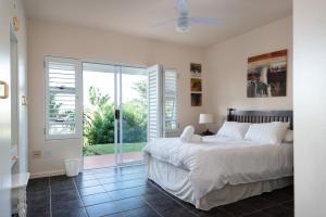 a bedroom with a bed and a sliding glass door at Long Island 19 in Ballito