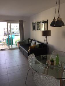 a living room with a couch and a table and chairs at Corralejo Sun 312 in Corralejo