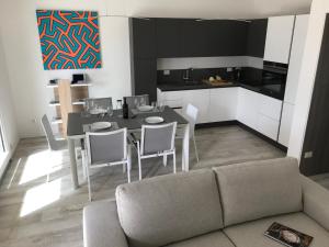 a kitchen and dining room with a table and chairs at Villa BOREA in Golfo Aranci