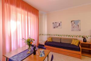 a bedroom with a bed and a desk and a table at Casa Vacanze Isophylla in Finale Ligure