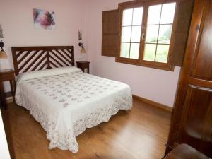 Łóżko lub łóżka w pokoju w obiekcie Apartamentos Rurales Casa Tata