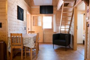 ein Esszimmer mit einem Tisch, Stühlen und einer Leiter in der Unterkunft Waldhaus Hilde in Suderburg