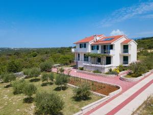 an aerial view of a house with a garden at Agata Apartments in Novalja