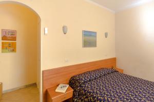 A bed or beds in a room at Casa Vacanze Isophylla