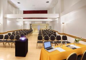 a room with rows of chairs and a laptop on a table at Hotel Dolmen in Buenos Aires