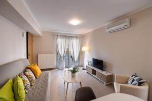 a living room with a couch and a table at La Strada Apartment in Lefkada