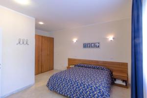 A bed or beds in a room at Casa Vacanze Isophylla