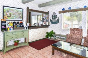 a room with a desk and a chair and a mirror at Svendsgaard's Lodge- Americas Best Value Inn & Suites in Solvang