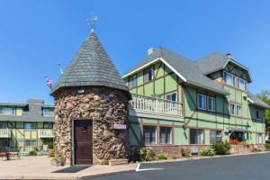 a large building with a clock tower in front of it at Svendsgaard's Lodge- Americas Best Value Inn & Suites in Solvang