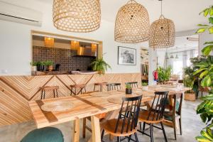 een eetkamer met een grote houten tafel en stoelen bij Selina Ericeira by IKIGAI Global Hospitality in Ericeira