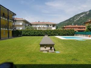 a small house in the middle of a yard at Appartamento Benji1 in Nago-Torbole