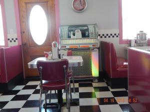 a dining room with a table and a pizza oven at Summer Nites in North Wildwood