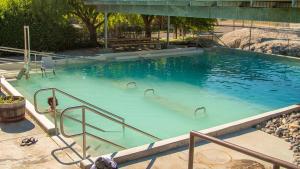 a large pool of blue water with a person in it at Two Rivers Inn in Thermopolis