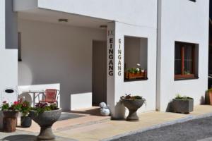 a group of potted plants sitting outside of a building at Gästehaus Judith in Sölden