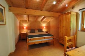 a bedroom with a bed and a wooden ceiling at Casa Paradiso in Tremosine Sul Garda