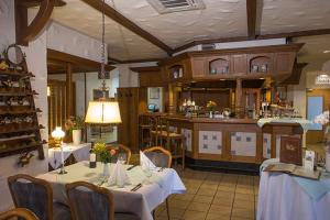 a dining room with two tables and a kitchen at Hotel Restaurant Brintrup in Münster