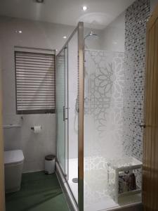 a bathroom with a shower with a glass door at 2 ROOMS ANNEX (TV+WiFi) in Chigwell