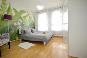 a bedroom with a bed and a large window at Clean&Cozy Apartments Novi Beograd in Belgrade