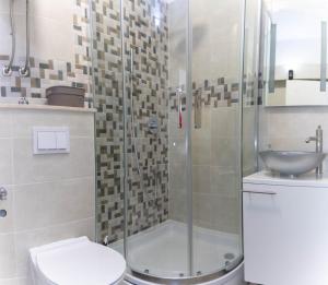 a bathroom with a shower and a toilet and a sink at Casteletti in Kaštela +34 photos