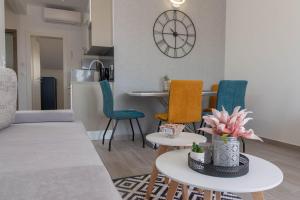 a living room with a couch and chairs and a table at Casteletti in Kaštela