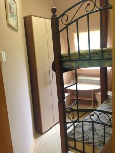 a spiral staircase leading to a room with a bunk bed at Hostel Little in Kostroma